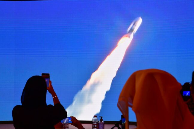 A picture taken on July 19, 2020, shows a screen broadcasting the launch of the 